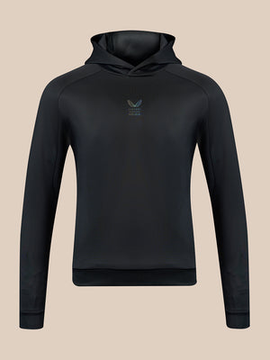 A black hooded sweatshirt shown from the back, featuring raglan sleeves and a ribbed hem and cuffs, displayed on a solid beige background.