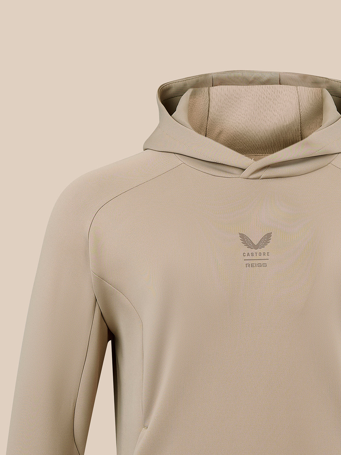 Upper chest of beige Reiss Flex Hoodie with hood and CASTORE REISS logo