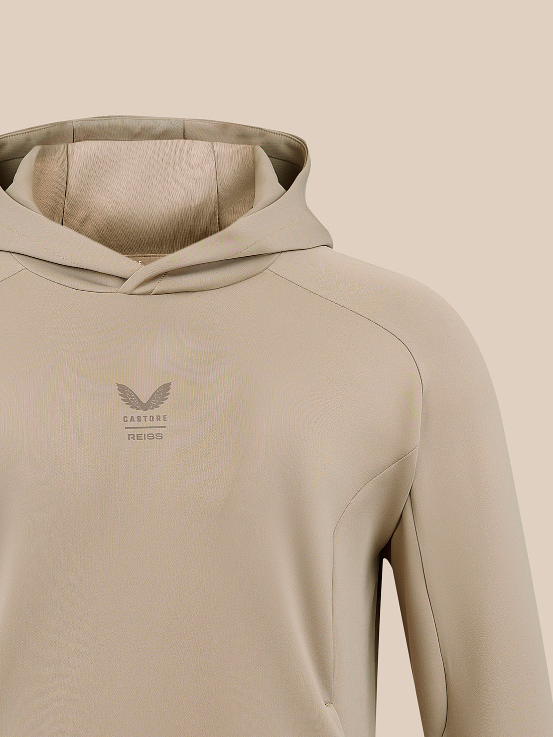 Beige hooded sweatshirt with a small Castore Reiss emblem on the chest.
