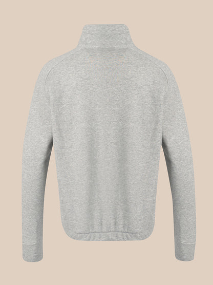 A light gray heather knit sweater with a mock neck or high collar, shown from the back on a solid beige background.