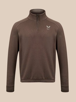 A brown long-sleeve quarter-zip pullover sweater with a small white winged logo on the left chest, displayed on a neutral beige background.