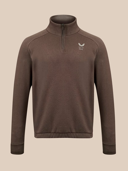A brown long-sleeve quarter-zip pullover sweater with a small white winged logo on the left chest, displayed on a neutral beige background.