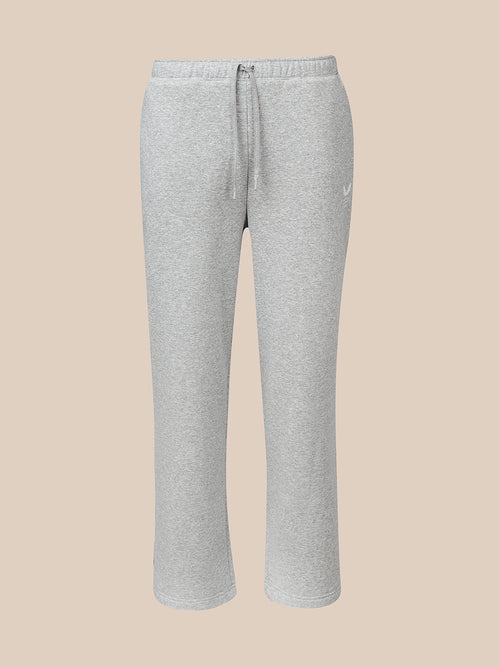 Light heather gray sweatpants with an elastic waistband and drawstring, featuring a small white Castore logo on the left hip, shown against a solid beige background.