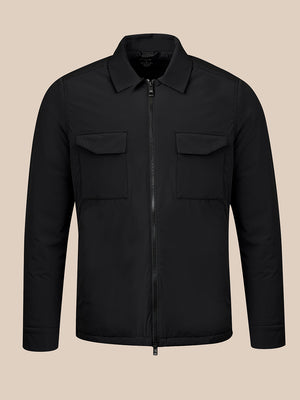 A black zip-up jacket with a collar, two chest flap pockets, and long sleeves, shown on a plain beige background.