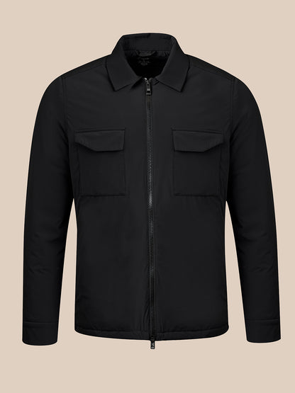 A black zip-up jacket with a collar, two chest flap pockets, and long sleeves, shown on a plain beige background.