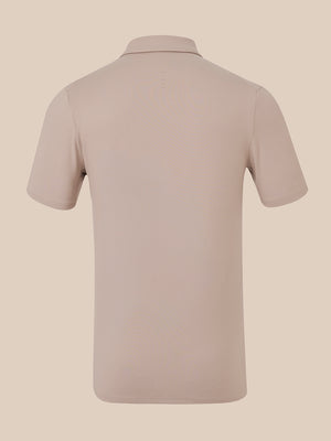 A short-sleeve polo shirt shown from the back, in a solid light taupe-beige color, displayed on a matching neutral beige background.