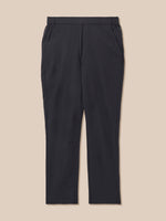 A pair of black trousers with an elastic waistband, displayed flat against a solid beige background.