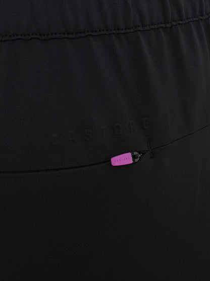 Close up of black elevated lifestyle slim fit trousers with elastic waistband and pink zip pull on back pocket