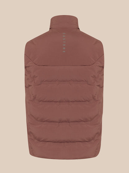 A brown puffer vest shown from the back, featuring horizontal quilting and a small vertical 'CASTORE' logo printed on the upper back, set against a solid beige background.