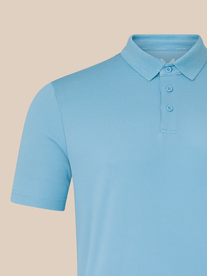 Close-up of the light blue polo collar and button placket on a men's Core Golf Polo