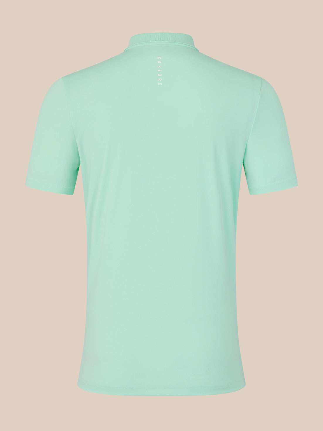 Back view of mint green polo showing vertical Castore lettering at the neck.