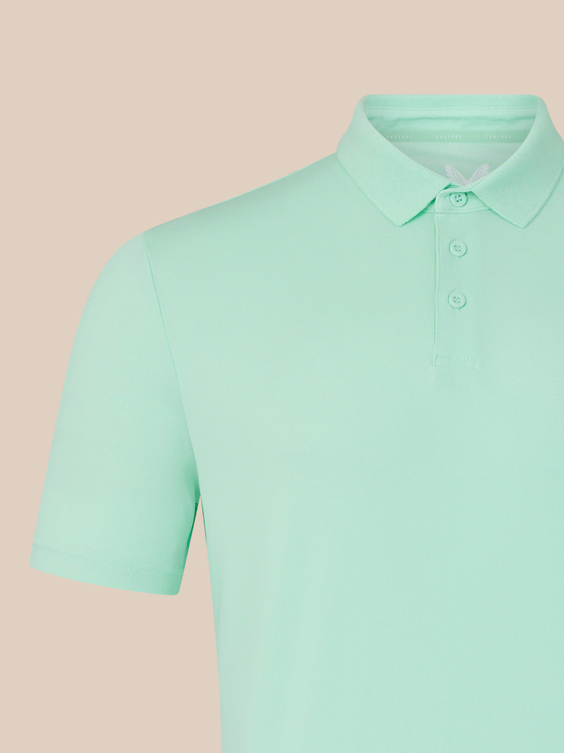 Close-up of the mint green polo collar with button placket.