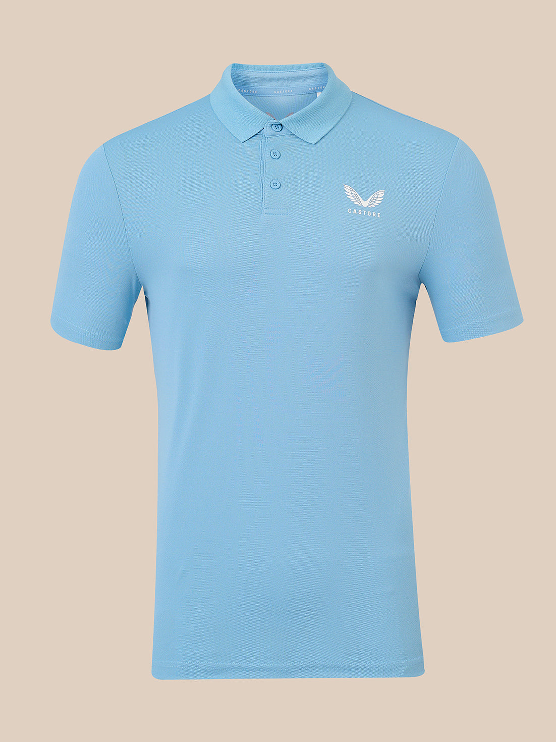 A light blue short-sleeve polo shirt with a three-button placket and a small white wing logo on the left chest, displayed on a solid beige background.