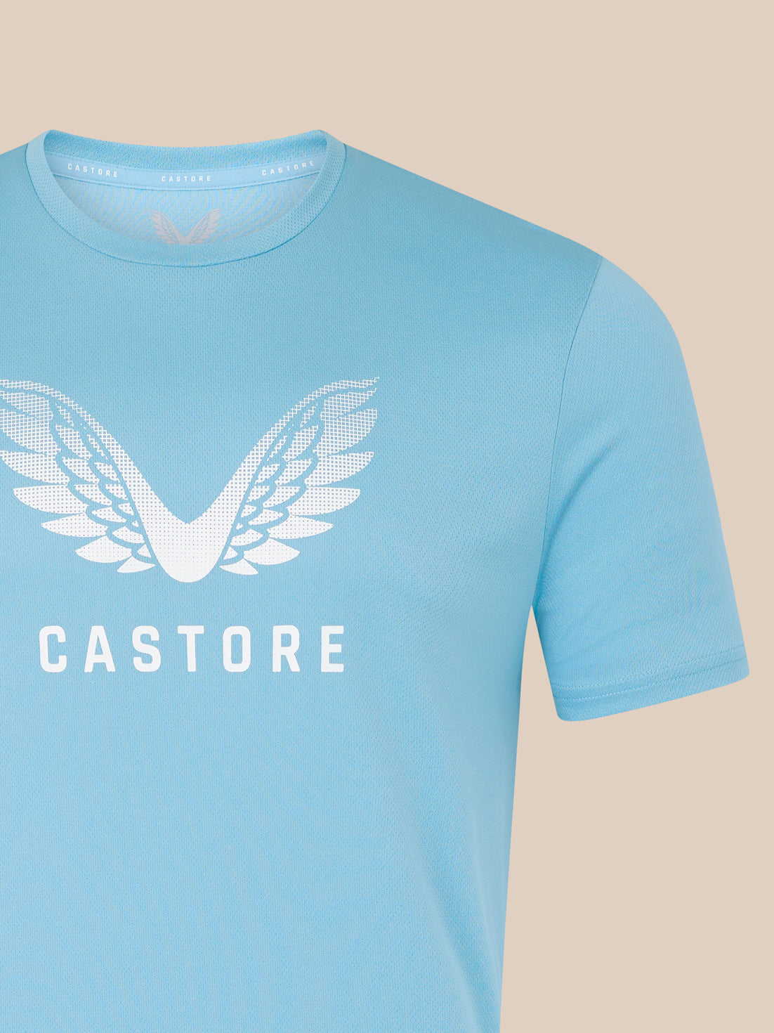 Light blue men's T shirt with a large white wing graphic and CASTORE branding on the chest.