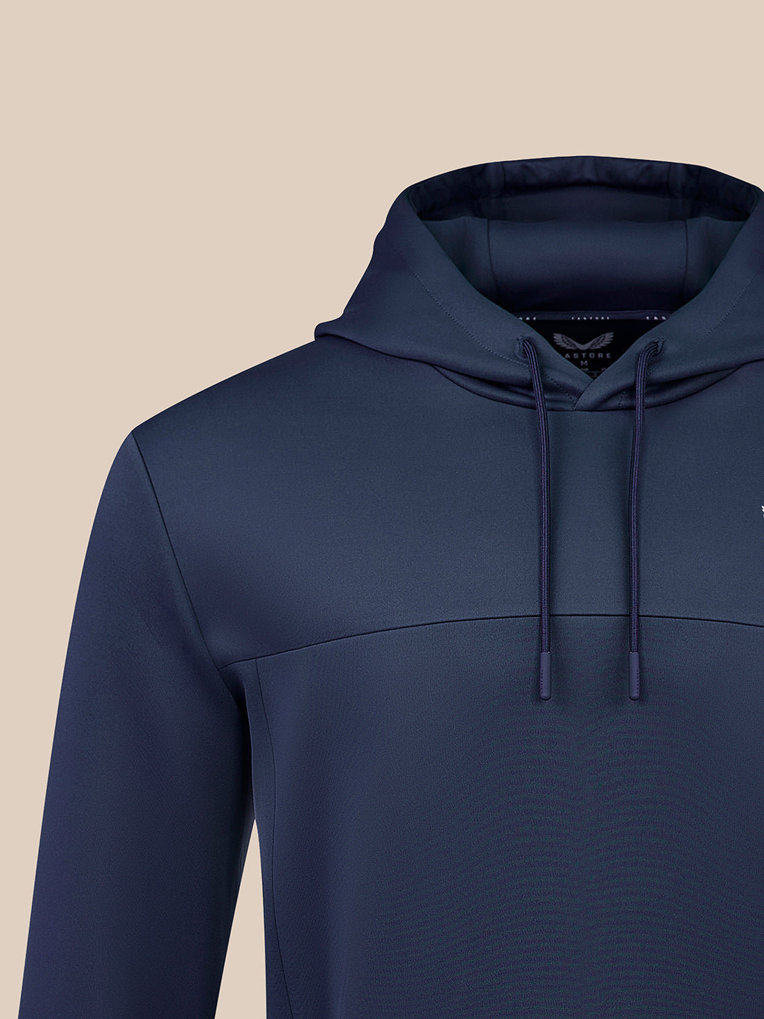 Hooded navy hoodie close-up showing drawstrings and Castore logo on the chest.
