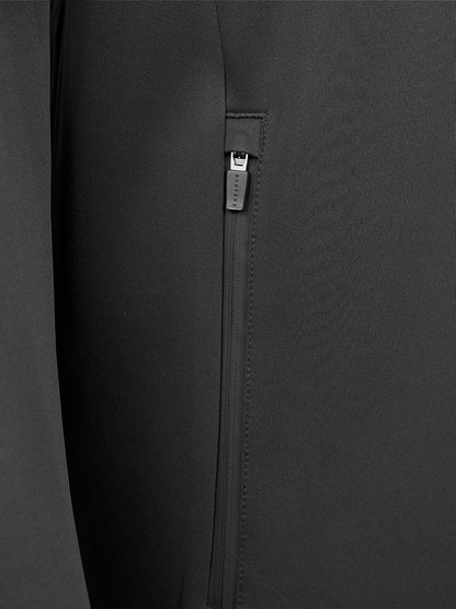 Close-up of a black zippered pocket on a dark gray or black fabric garment, showing the zipper pull and stitching details.
