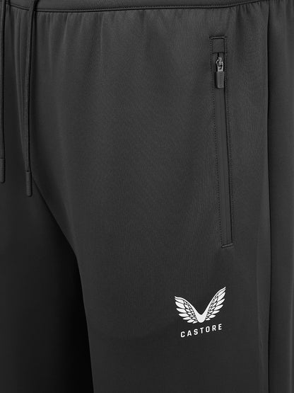 Close-up of black athletic pants showing a side zip pocket and a white Castore wing logo on the lower leg.