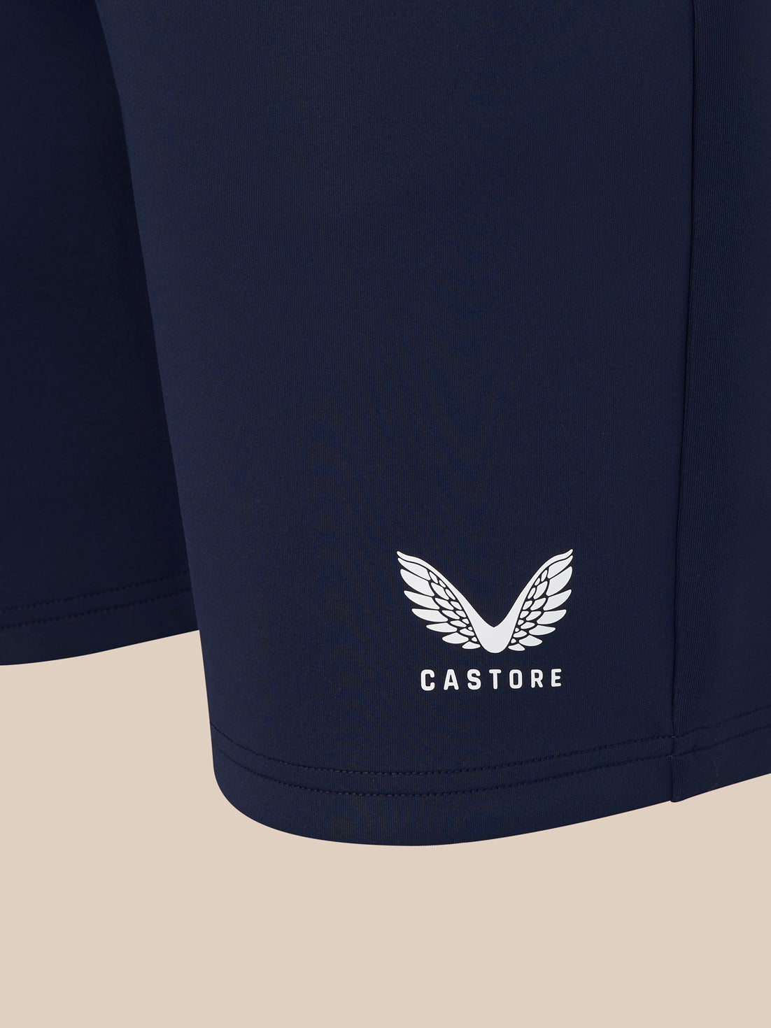 Navy men's flex shorts with white Castore logo at the hem.
