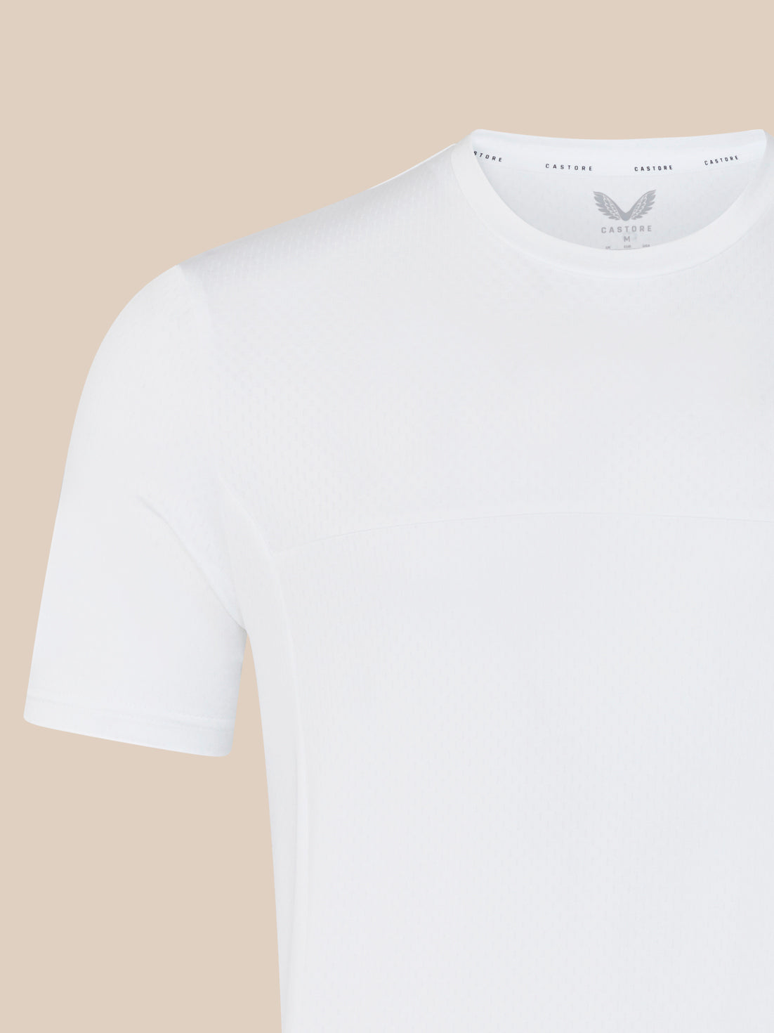 Close-up of shoulder and neckline on white training T shirt showing subtle textured fabric
