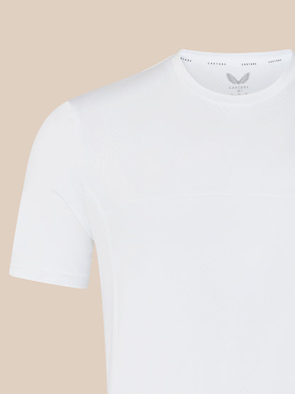 Close-up of shoulder and neckline on white training T shirt showing subtle textured fabric