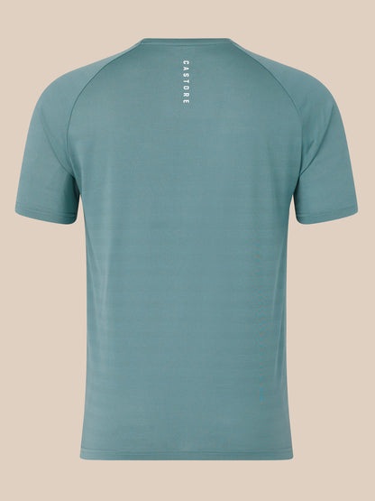 Back view of blue short sleeve performance T shirt showing vertical CASTORE branding along the upper back.