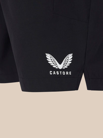 Close up of black shorts lower leg with a white winged Castore logo
