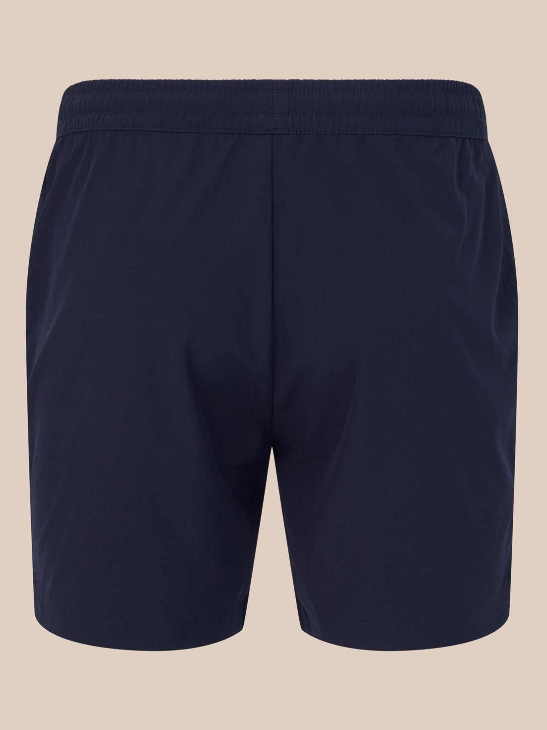 Back view of navy 6 inch training shorts with a white Castore logo near the hem.
