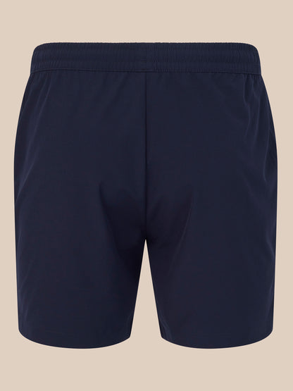 Back view of navy 6 inch training shorts with a white Castore logo near the hem.