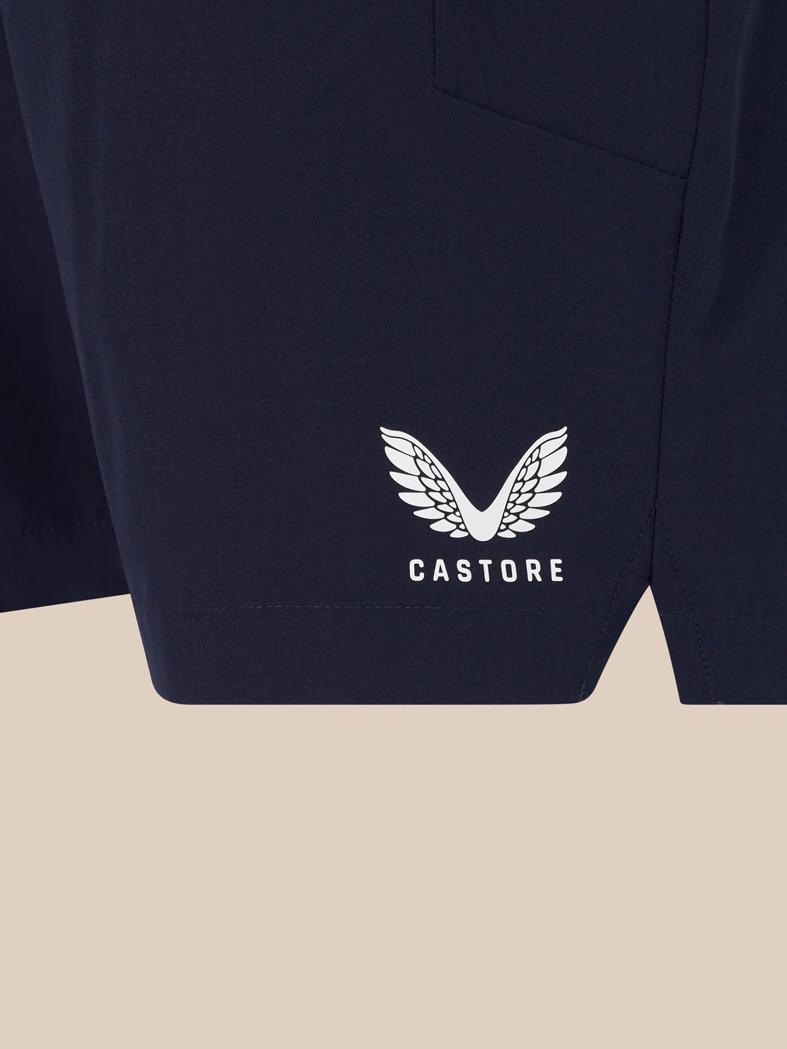 Navy shorts with white Castore wing logo near the hem.