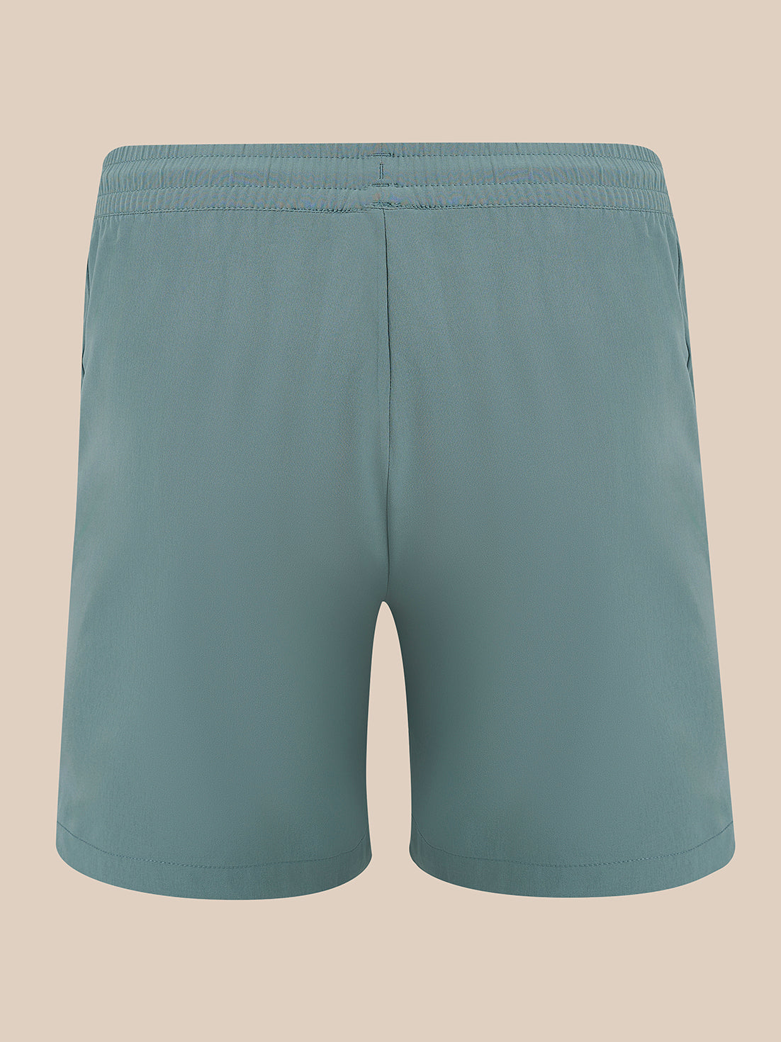 A pair of solid teal-blue athletic shorts with an elastic waistband, shown from the back against a solid beige background.
