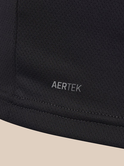 Close-up of a black athletic fabric with the AERTEK logo printed in gray near the lower center, showing a stitched hem and a light beige background at the bottom.