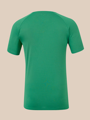 A green short-sleeve athletic t-shirt shown from the back, featuring raglan sleeves and a crew neck, displayed on a solid beige background.