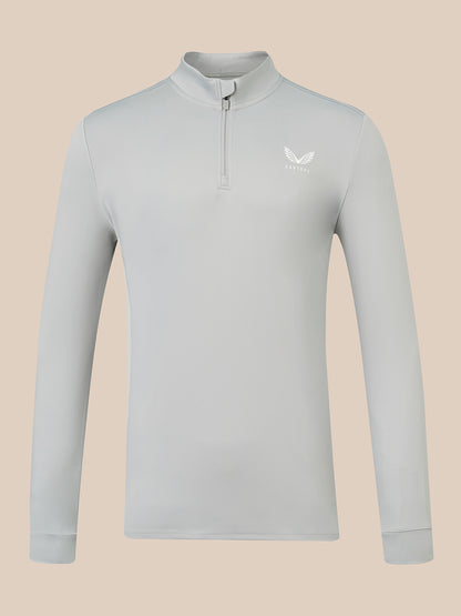 A light gray long-sleeve quarter-zip pullover with a small white wing logo on the left chest, displayed on a solid beige background.
