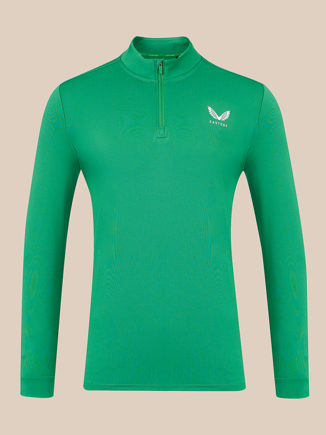 A green long-sleeve quarter-zip pullover with a small white wing logo and the brand name 'Castore' on the left chest, displayed on a solid beige background.
