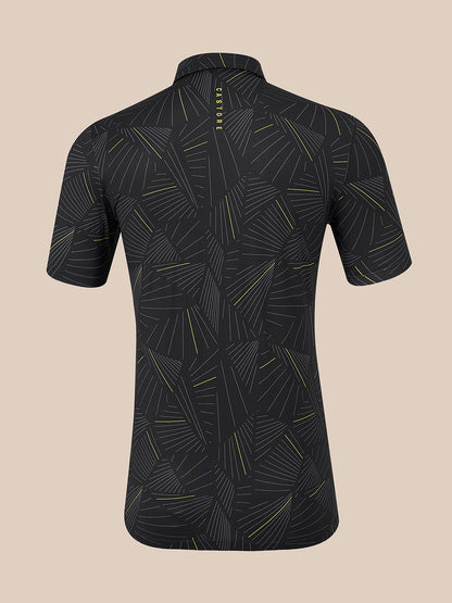 A short-sleeve polo shown from the back, featuring a dark charcoal gray base with a repeating geometric leaf pattern in light gray and thin yellow lines. The brand name 'CASTORE' is printed vertically in yellow near the collar.