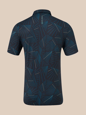 A short-sleeve polo shirt shown from the back, featuring an abstract geometric pattern in dark navy and teal with thin white line accents, set against a solid beige background.