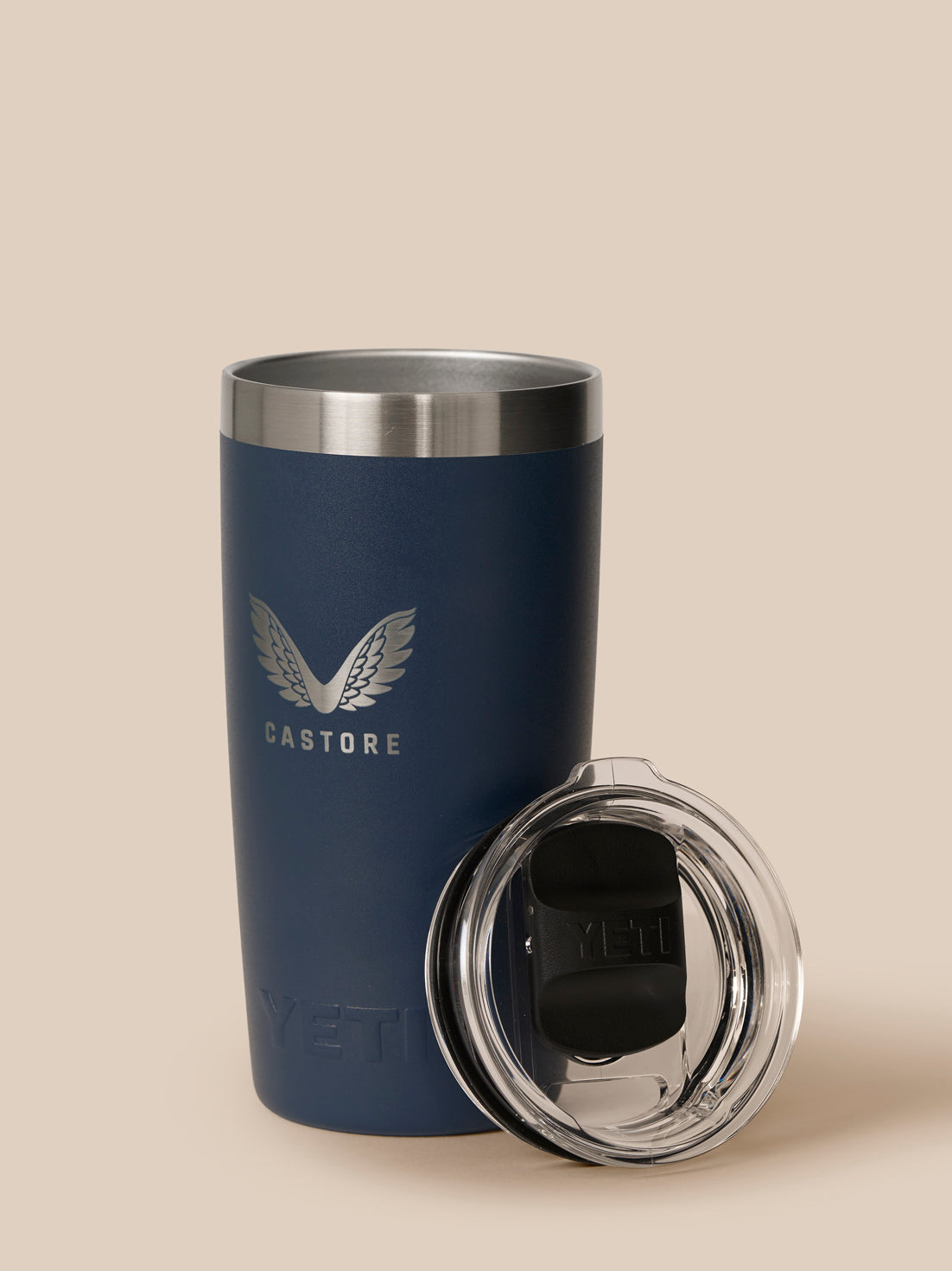 Navy YETI Castore 300ml tumbler with detached clear lid resting beside the cup
