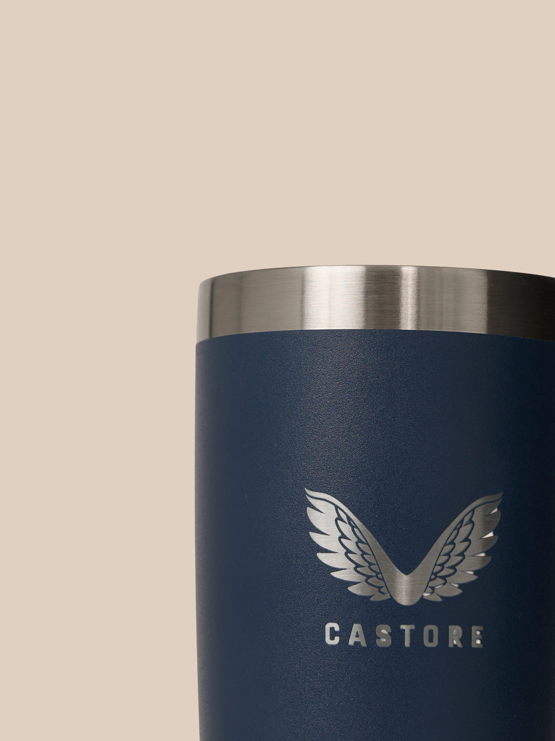 Close-up of navy blue YETI Castore Tumbler 300ml showing brushed metal rim and CASTORE logo