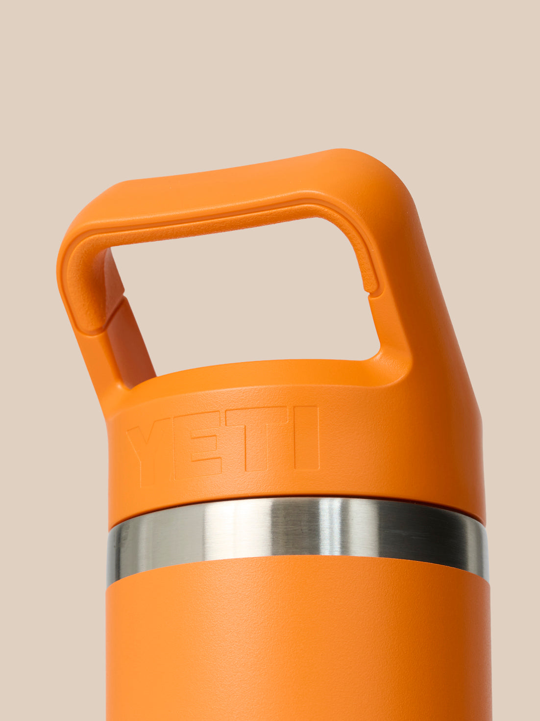 Close up of the orange cap area with a built in handle and YETI branding on the side