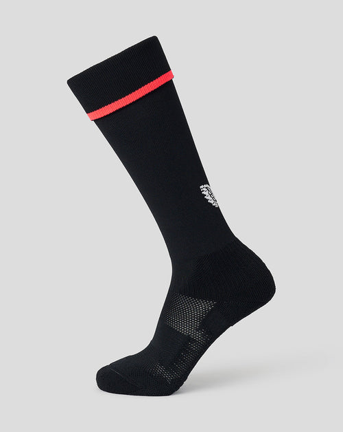 A single black crew sock with a bright red stripe near the cuff and a small white embroidered logo, shown on a light gray background.