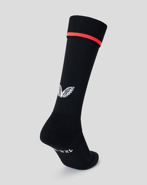A single black crew sock with a white wing logo on the side and a thin red stripe near the cuff, shown on a light gray background.