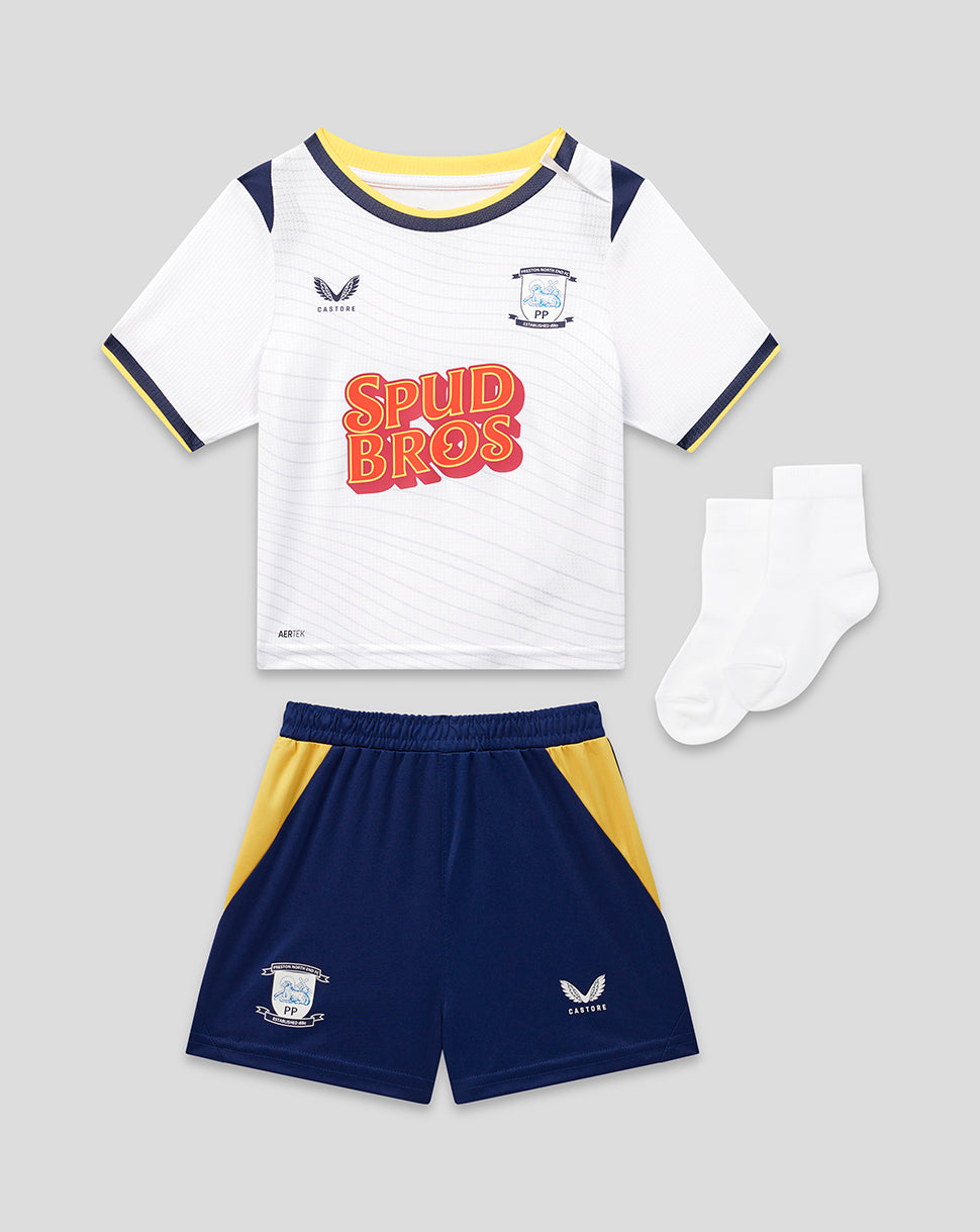 Children's sports outfit with white jersey, navy shorts, and socks on a gray background
