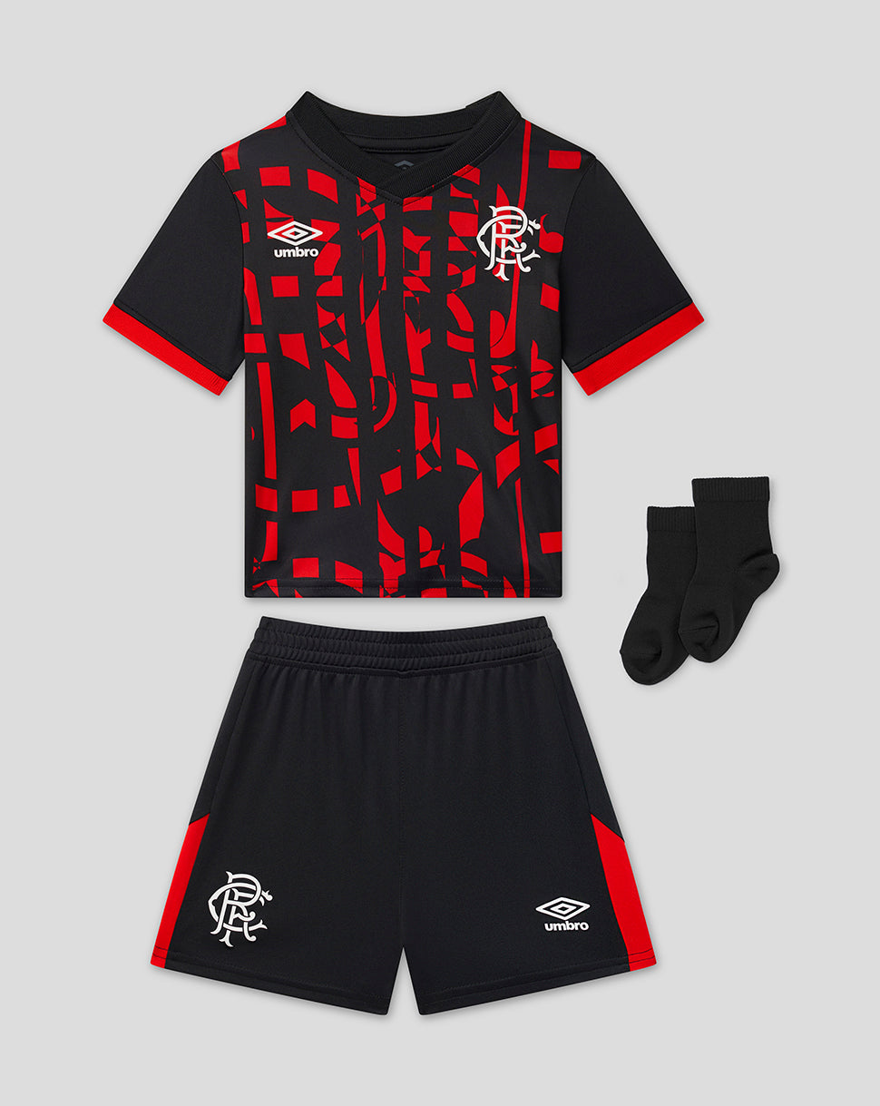 A 3-piece kids' Rangers kit by Umbro, including a short-sleeve patterned jersey, matching shorts, and a pair of black socks, displayed on a light gray background.