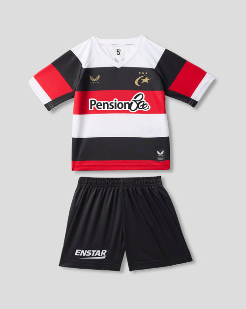 A kids' two-piece sports kit featuring a short-sleeve striped jersey and matching shorts. The jersey has horizontal stripes of white, red, and black, with a 'PensionBee' sponsor logo across the chest, a gold wing logo on the right chest, and a gold star logo on the left chest.