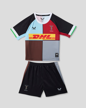 Harlequins 2026/27 home infant kit with a multicolor quartered shirt and black shorts