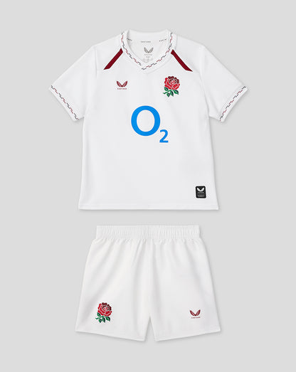 Infant white home rugby kit laid out with jersey featuring a rose crest and O2 logo and matching shorts.