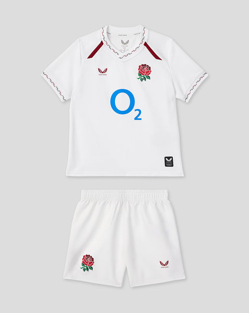 Infant white home rugby kit laid out with jersey featuring a rose crest and O2 logo and matching shorts.