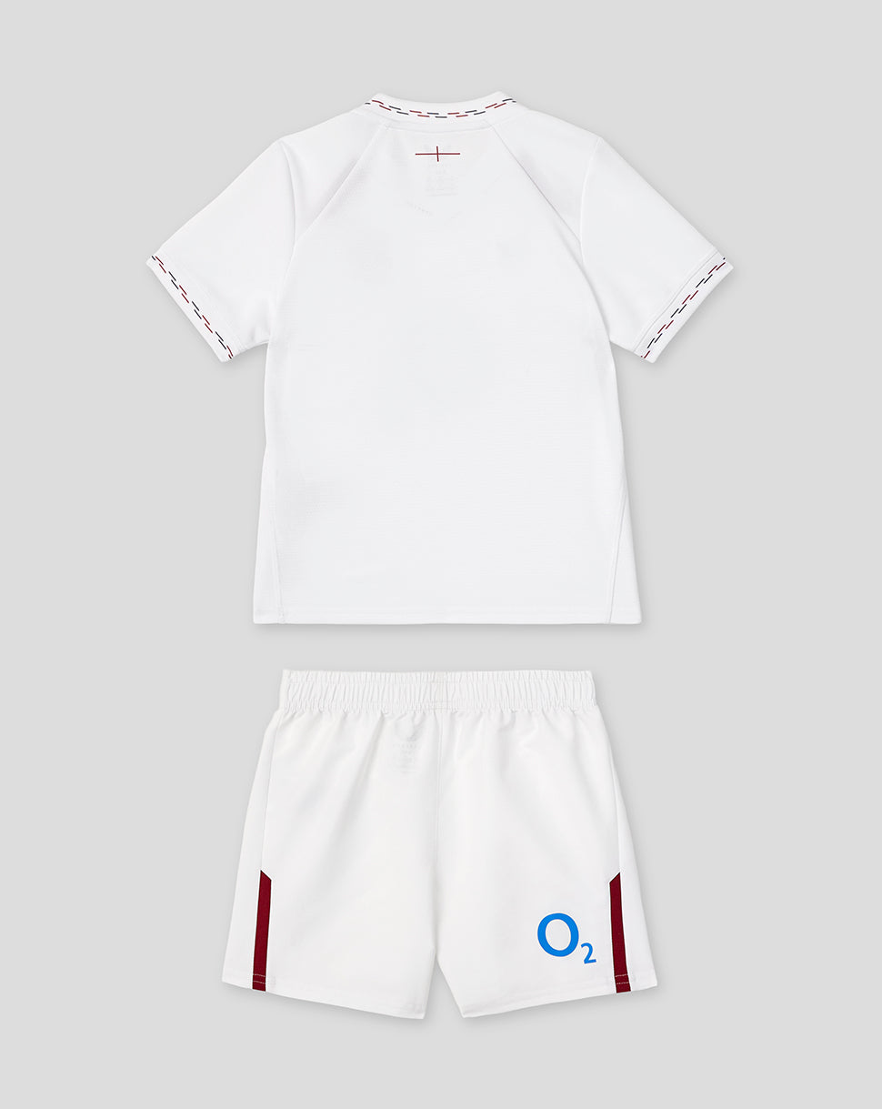 England Rugby infant white home kit shirt and shorts laid flat with Red Rose crest on the shirt and O2 logo on the shorts