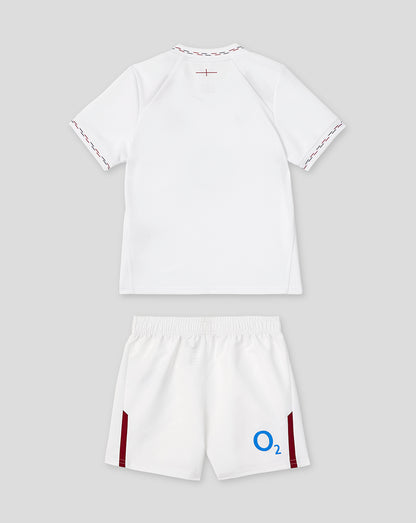 England Rugby infant white home kit shirt and shorts laid flat with Red Rose crest on the shirt and O2 logo on the shorts
