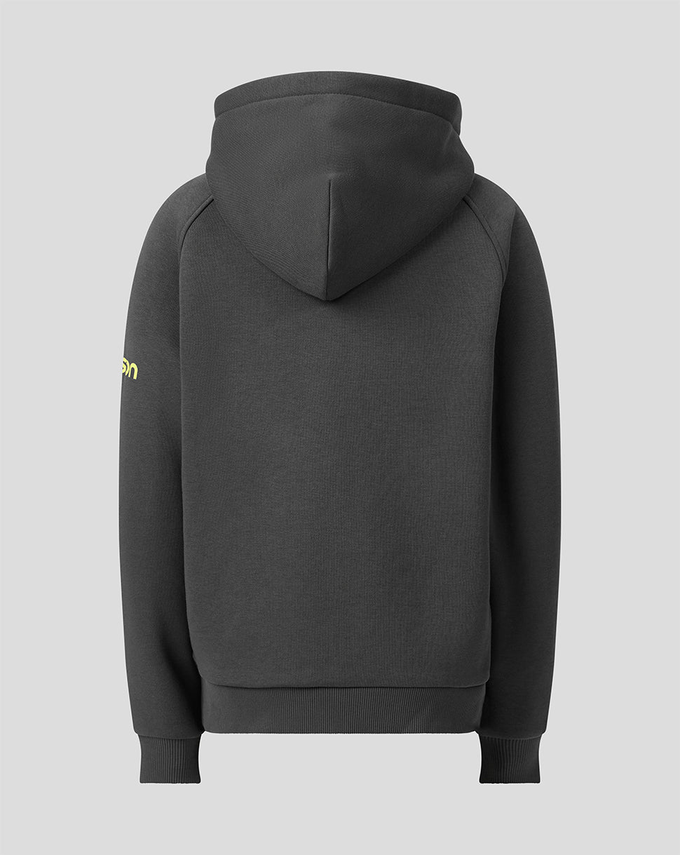 A dark gray pullover hoodie shown from the back, featuring a small yellow graphic on the left sleeve, set against a solid light gray background.